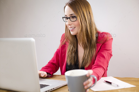 Successful young entrepreneur typing on her laptop