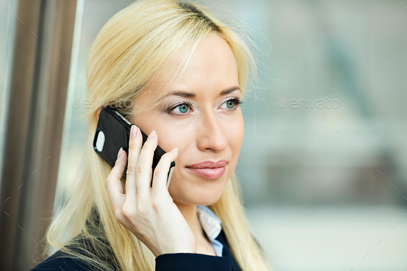 Serious business woman having conversation on phone