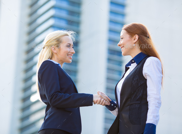 Business women shaking hands
