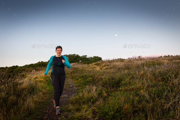 Active woman sprinting downhill early morning (Misc) Photo Download