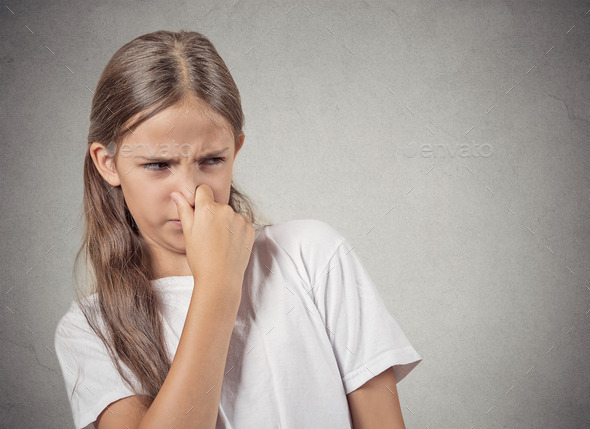 teenager girl pinches nose, something stinks