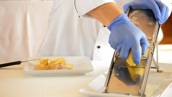 VideoHive Peeling and Cutting a Potato with a Mandolin 9533832 VideoHive Peeling and Cutting a Potato with a Mandolin 9533832