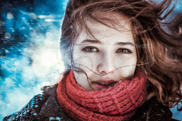 Beautiful brunette girl blowing star dust - winter portrait