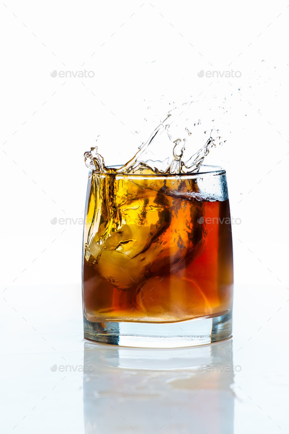 Glass of scotch whiskey and ice on a white background (Misc) Photo Download