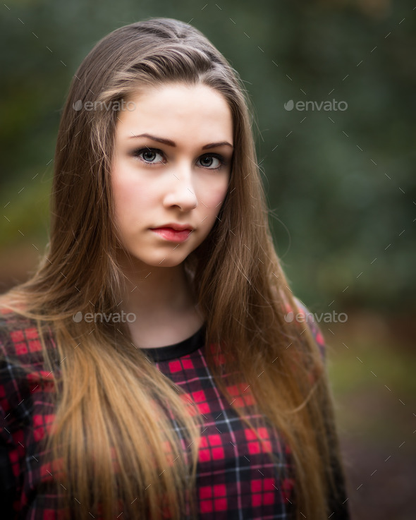 Portrait of a Beautiful Dark Blond Teenage Girl in a Forest