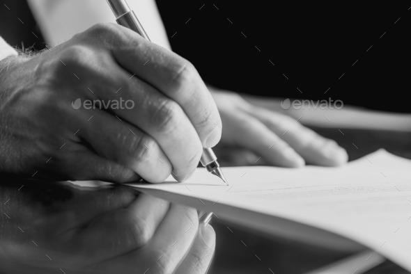 Businessman signing a business document
