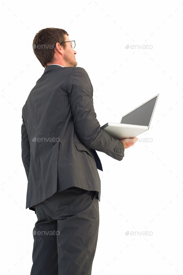 Businessman looking up holding laptop on white background (Misc) Photo Download