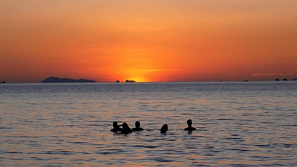 Friends Enjoying Sea at Sunset Friends Enjoying Sea at Sunset