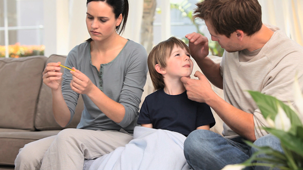 Parents Checking Their Sons Fever Parents Checking Their Sons Fever