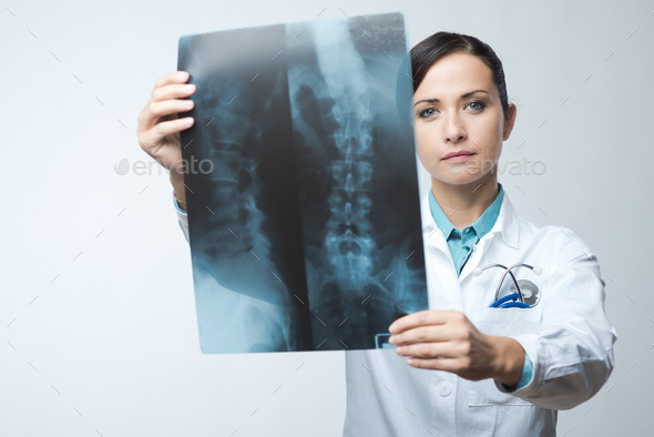 Female radiologist checking x-ray image