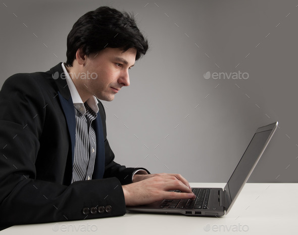 business man staring at his laptop (Misc) Photo Download