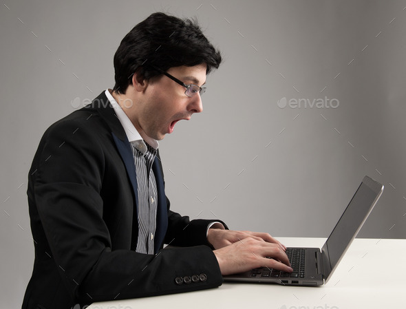 shocked businessman staring at his laptop (Misc) Photo Download