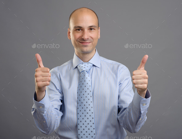 smiling businessman showing thumbs up sign (Misc) Photo Download