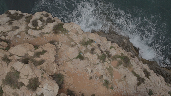 Rocky Coast and Sailboat out at Sea Aerial Drone Rocky Coast and Sailboat out at Sea Aerial Drone