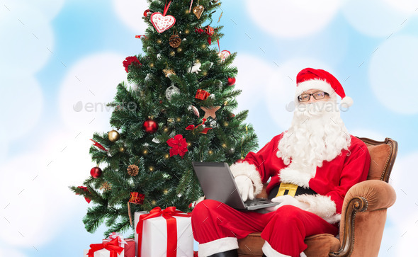 man in costume of santa claus with laptop (Misc) Photo Download