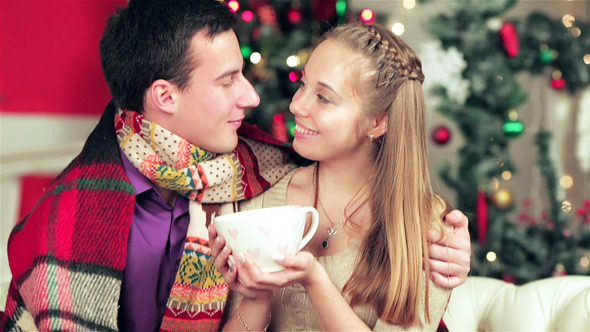 Young Beautiful Couple In Sweaters And Scarves Young Beautiful Couple In Sweaters And Scarves