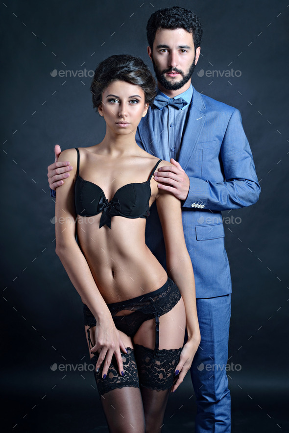 Handsome man in the blue suit touches the girl27;s shoulders
