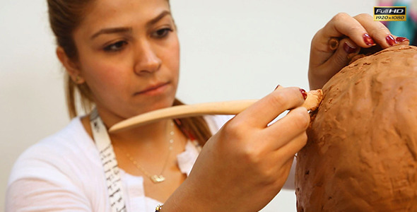 Woman Working On Clay Sculpture in Art Class Woman Working On Clay Sculpture in Art Class