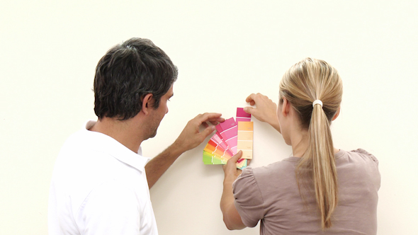 Couple Choosing Colours To Paint New House Couple Choosing Colours To Paint New House