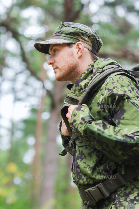 young soldier with backpack in forest (Misc) Photo Download