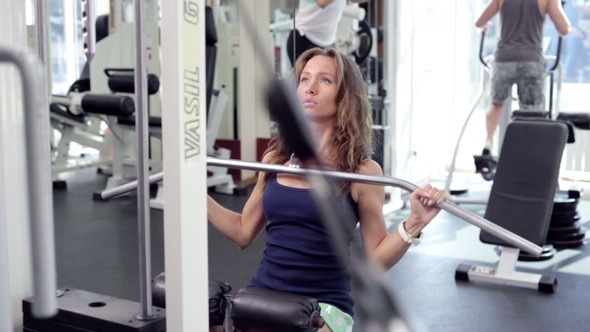 Young Woman Uses Lat Machine Young Woman Uses Lat Machine