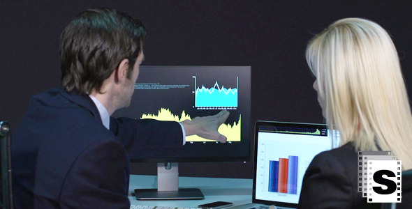Business Couple Analyzing Graphs Business Couple Analyzing Graphs