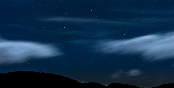 Stars Moving In Night Sky Over Mountain Ridge Stars Moving In Night Sky Over Mountain Ridge