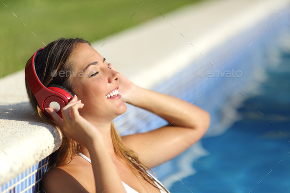 Relaxed woman listening to the music with headphones