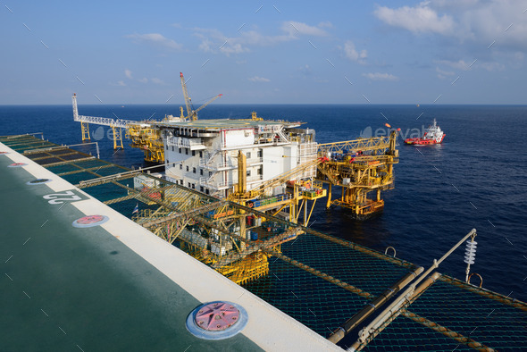 The offshore oil rig and supply boat in the gulf of Thailand
