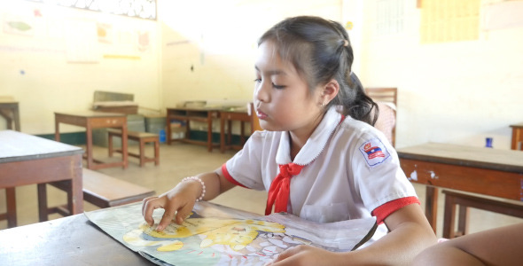 Kid Students in Traditional Clothes Reading Kid Students in Traditional Clothes Reading