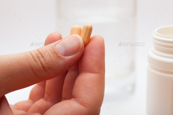 Pills in woman's hand (Misc) Photo Download