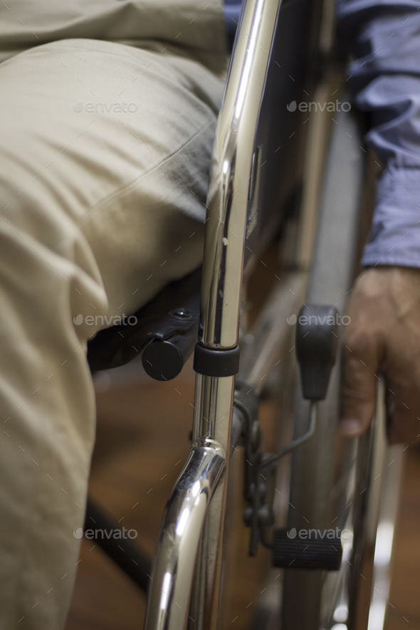 Man in wheel chair in hospital clinic closeup on wheel (Misc) Photo Download