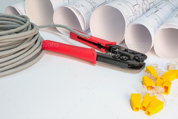 Drawing rolls, cat 5 cable, crimping pliers, connectors and boot caps composition (Misc) Photo Download