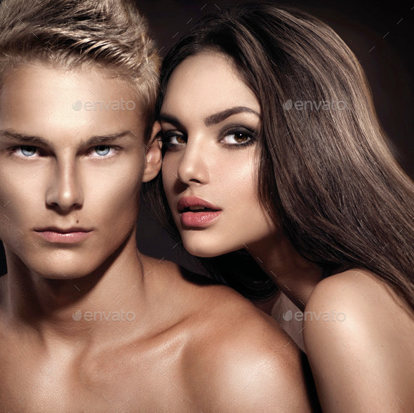 Sexy couple. Young man with his girlfriend posing together