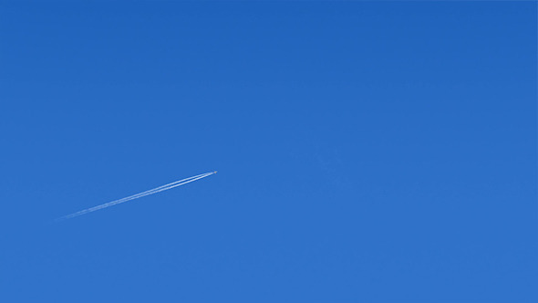Plane Flies Across Blue Sky Plane Flies Across Blue Sky