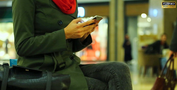 Young Woman With Cell Phone in Shopping Center Young Woman With Cell Phone in Shopping Center