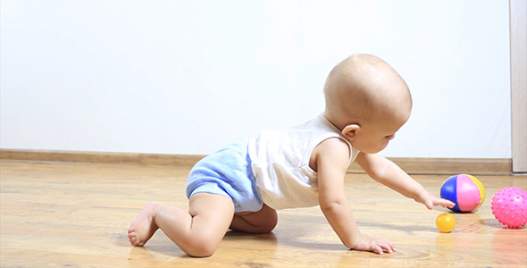 Little Baby Crawling on Floor to a Toy Little Baby Crawling on Floor to a Toy