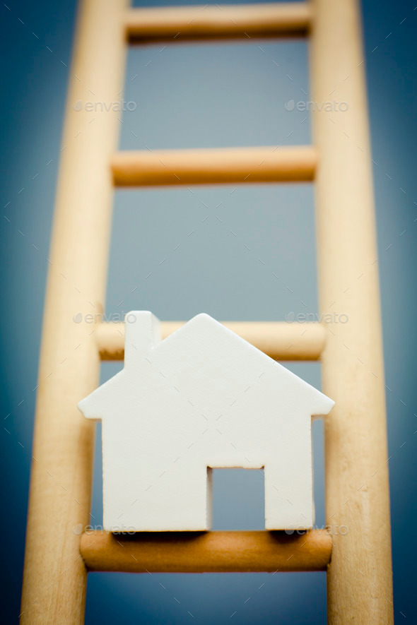 Model House On Rung Of Wooden Property Ladder