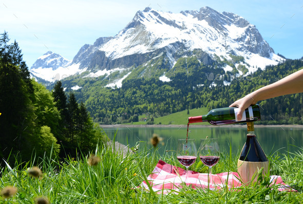 Wine served at a picnic in Alpine meadow. Switzerland
