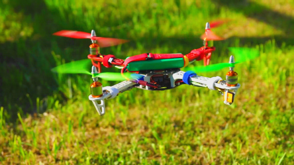 Quadcopter Drone Flies Over the Field Quadcopter Drone Flies Over the Field