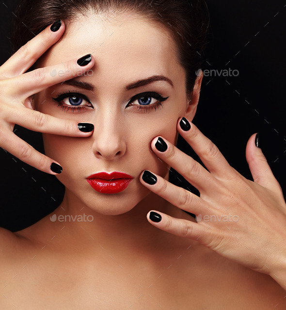 Sexy fashion model with bright makeup and black manicure on hands. Beauty health skin