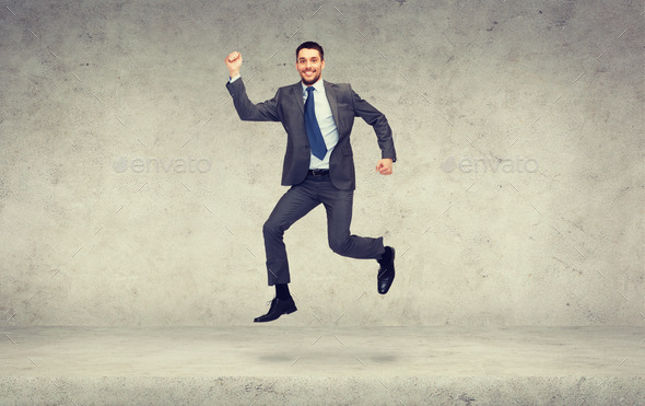 smiling businessman jumping (Misc) Photo Download