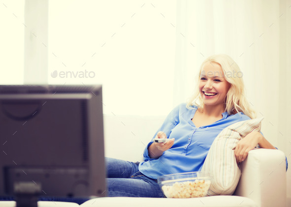 young girl with popcorn watching movie at home (Misc) Photo Download