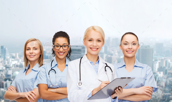smiling female doctor and nurses with stethoscope (Misc) Photo Download