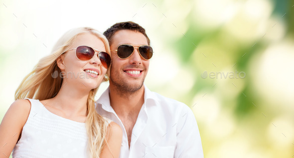 happy couple in shades over green background (Misc) Photo Download