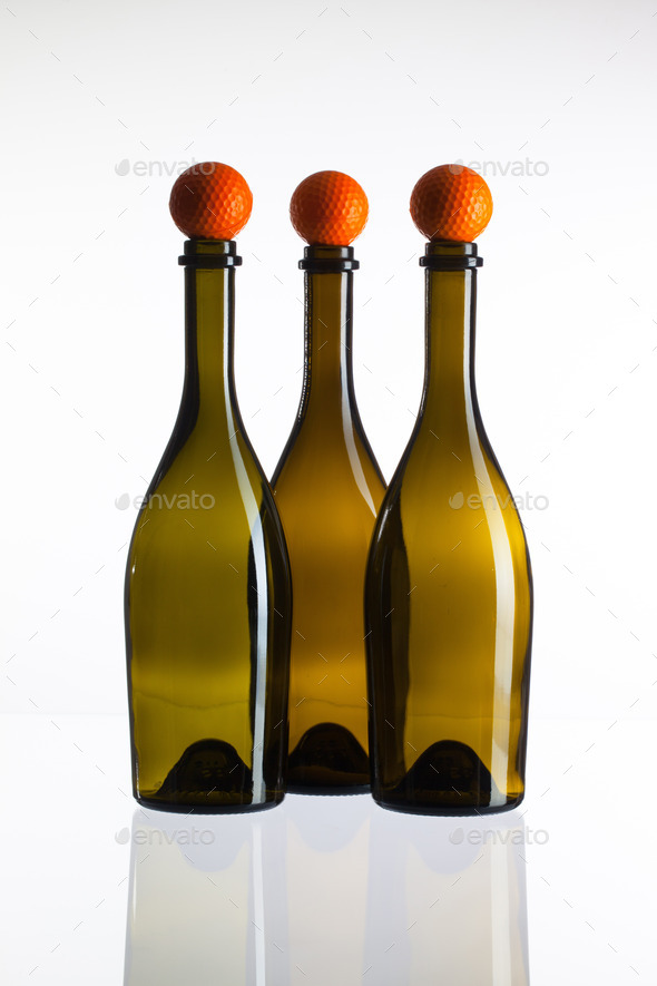 Empty three wine bottles and golf balls (Misc) Photo Download