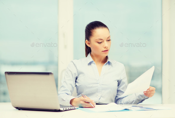 businesswoman with laptop and charts in office (Misc) Photo Download