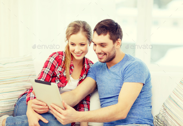 smiling couple with tablet pc computer at home (Misc) Photo Download