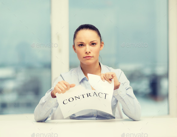 serious businesswoman tearing contract (Misc) Photo Download