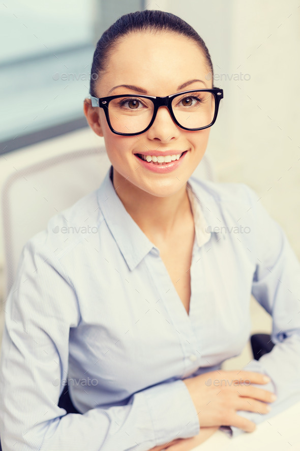 smiling businesswoman in eyeglasses in office (Misc) Photo Download